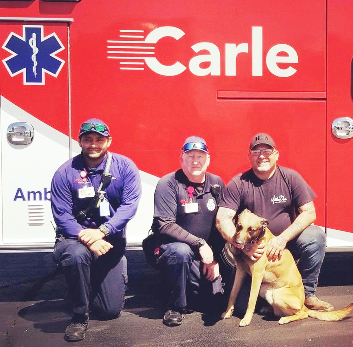 Carle drivers with man, dog they saved.jpg